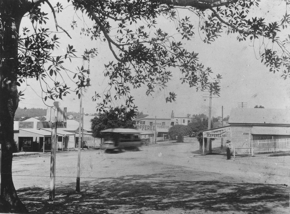 Black and White image of Annerley in the past with a tram on the street.