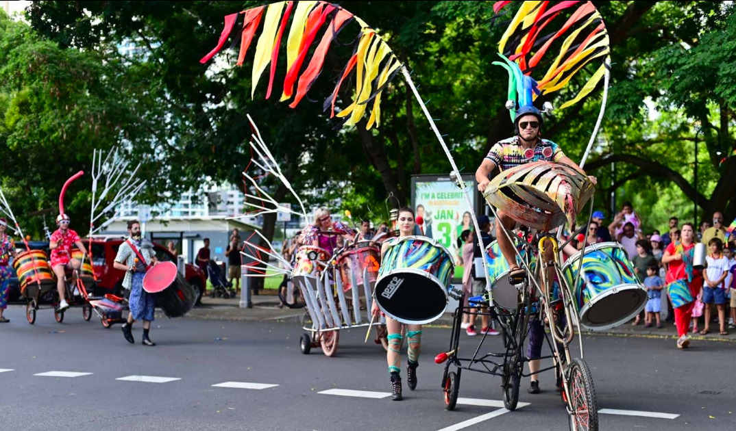 A bicycle decorated with wings and drums