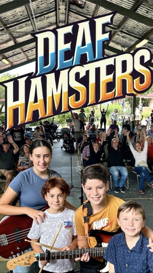 4 young people standing with instruments in front of people cheering.